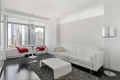 a white living room with a white couch and red chairs at Financial District 1br w WD gym elevator NYC-1368 in New York