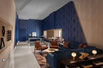 a living room with blue walls and a blue couch at Financial District 1br w WD gym elevator NYC-1368 in New York