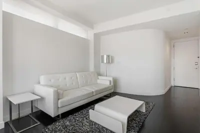 a white living room with a couch and a table at Financial District 1br w WD gym elevator NYC-1368 in New York