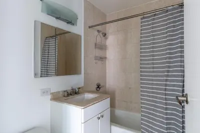 a bathroom with a sink and a shower at Midtown 1br w doorman wd nr Times Square NYC-1351 in New York