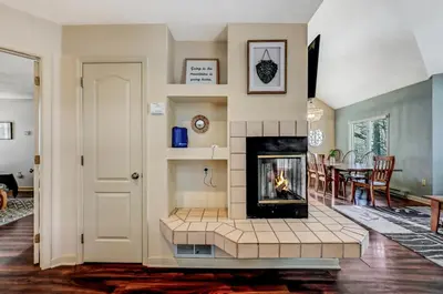 a living room with a fireplace and a table at Poconos Paradise Lakeskihikewater Parkkids in Lake Harmony