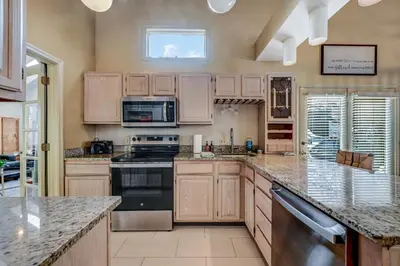 a large kitchen with wooden cabinets and granite counter tops at Poconos Paradise Lakeskihikewater Parkkids in Lake Harmony
