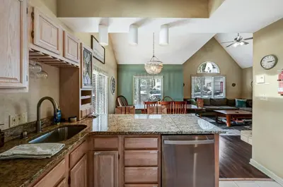 a kitchen with a sink and a living room at Poconos Paradise Lakeskihikewater Parkkids in Lake Harmony