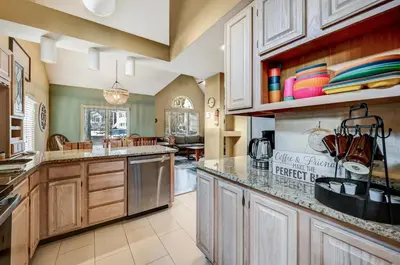 a kitchen with wooden cabinets and a counter top at Poconos Paradise Lakeskihikewater Parkkids in Lake Harmony
