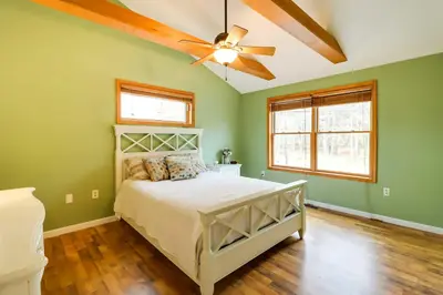 a bedroom with a bed and a ceiling fan at Lakefront Poconos Family Home with Pool Access in Pocono Lake