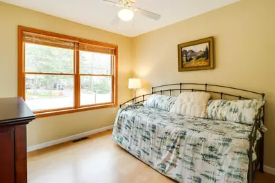 a bedroom with a bed and a window at Lakefront Poconos Family Home with Pool Access in Pocono Lake