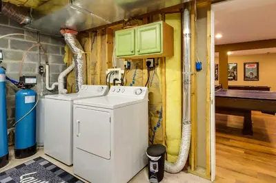 a washer and dryer in a room at Lakefront Poconos Family Home with Pool Access in Pocono Lake