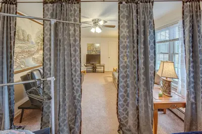 a living room with gray curtains and a desk at Tranquil Mt Pleasant Mills Retreat on 60-Acre Farm in Dalmatia