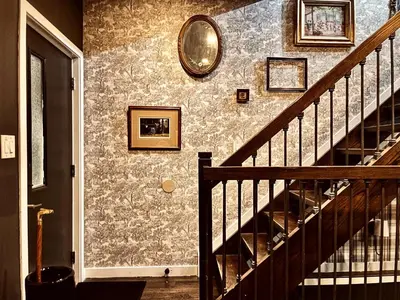 a hallway with a staircase and a mirror on a wall at Trio Sonata, 3-Bed Rock n Roll Residence in Northern Liberties in Philadelphia