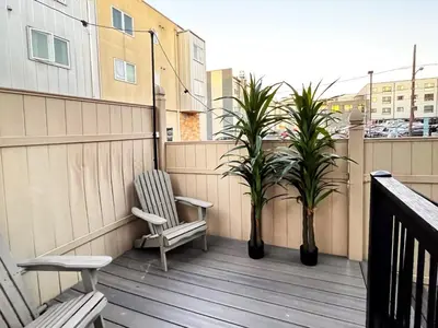 a balcony with two chairs and two plants on it at Trio Sonata, 3-Bed Rock n Roll Residence in Northern Liberties in Philadelphia
