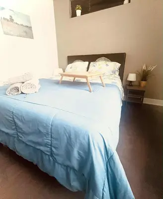 a bed with a wooden tray on top of it at Bright, Cozy Room Near Center City Philadelphia and Museums in Philadelphia