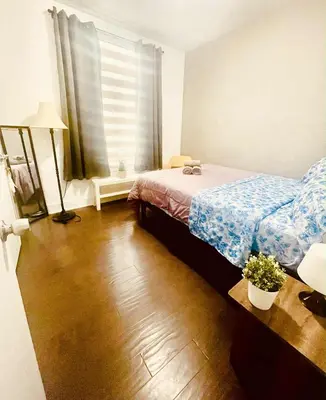 a bedroom with a bed and a wooden floor at Bright, Cozy Room Near Center City Philadelphia and Museums in Philadelphia