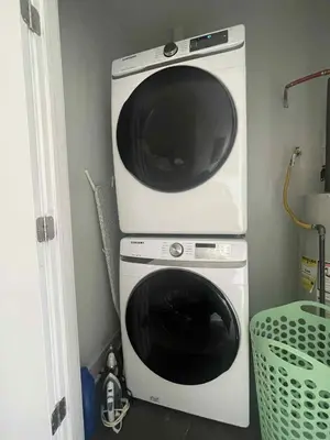 a microwave sitting on top of a washing machine at Bright, Cozy Room Near Center City Philadelphia and Museums in Philadelphia