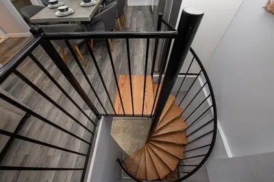 a spiral staircase in a house at Spectacular Times Square 5 Bedroom Duplex Oasis in New York
