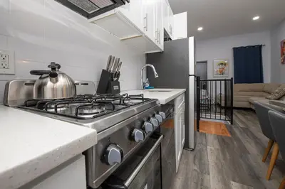 a kitchen with a stove top oven in a room at Spectacular Times Square 5 Bedroom Duplex Oasis in New York