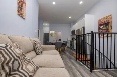 a living room with a couch and a table at Spectacular Times Square 5 Bedroom Duplex Oasis in New York
