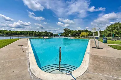 a swimming pool with blue water in a park at 1 Mi to Beach Pocono Lake Chalet with Decks in Pocono Lake