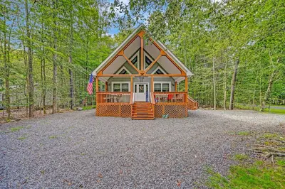 a small house in the middle of the forest at 1 Mi to Beach Pocono Lake Chalet with Decks in Pocono Lake