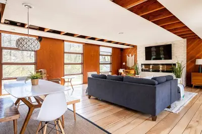 a living room with a couch and a table at Mid Century Modern Getaway with outdoor Hot Tub in Wernersville
