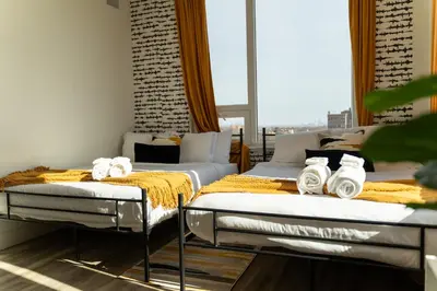 two beds sitting next to each other in a room at Bright and Bold Escape with NYC Views and Free Parking, Sleeps 9 and 2 Baths in Newark