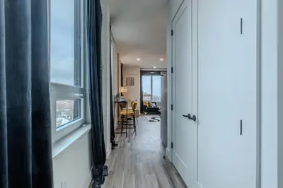 a hallway with a view of a room with a window at Bright and Bold Escape with NYC Views and Free Parking, Sleeps 9 and 2 Baths in Newark