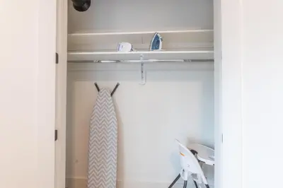 a tie hanging on a shelf in a closet at Bright and Bold Escape with NYC Views and Free Parking, Sleeps 9 and 2 Baths in Newark
