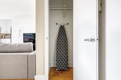 a tie hanging on a door in a room at Kips Bay 1BR w Doorman Elevator Gym NYC-478 in New York