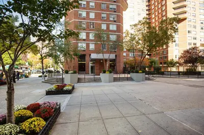 a sidewalk in a city with flowers and buildings at Kips Bay 1BR w Doorman Elevator Gym NYC-478 in New York