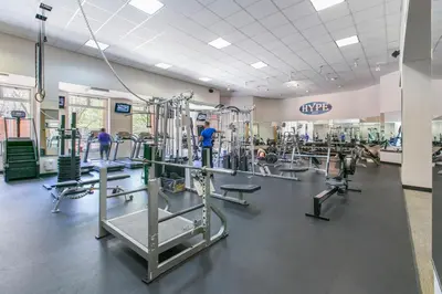 a gym with tread machines and people in the background at Kips Bay 1BR w Doorman Elevator Gym NYC-478 in New York