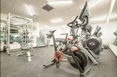 a gym with two exercise bikes and a treadmill at Spacious Luxury 2BD Downtown Gym W/D Doorman in New York