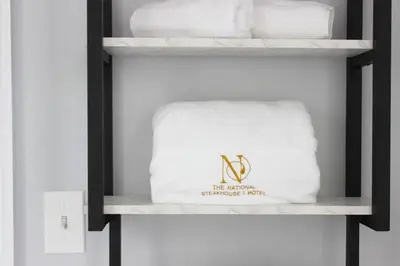 a shelf with a white towel and towels at The National Hotel in Frenchtown