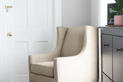 a white chair sitting next to a cabinet at The National Hotel in Frenchtown