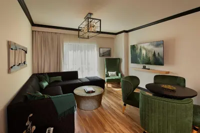 a living room with a couch and a table and chairs at The Swiftwater in Swiftwater