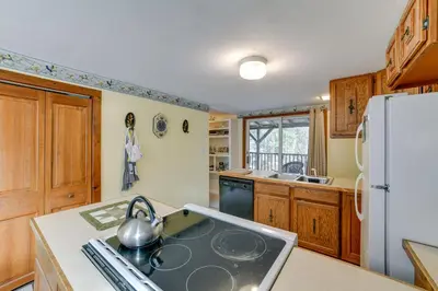 a kitchen with a stove and a refrigerator at Fire Pit and On-Site Pond Wooded Walton Home! in Walton