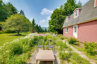 two chairs and a table in front of a house at Fire Pit and On-Site Pond Wooded Walton Home! in Walton