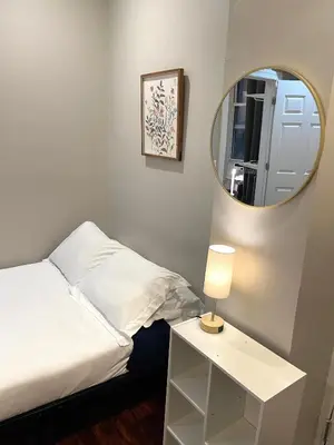 a bedroom with a white bed and a mirror at Nest 1 bedroom Aparthotel with kitchenette in New York