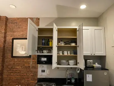 a kitchen with white cabinets and a microwave at Nest 1 bedroom Aparthotel with kitchenette in New York