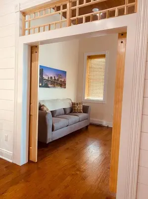 a living room with a couch and a loft bed at Church Bells in Wyalusing