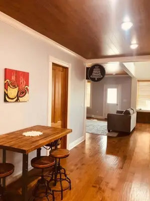 a living room with a wooden table and chairs at Church Bells in Wyalusing