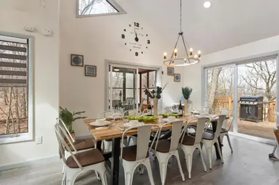 a dining room with a large wooden table and chairs at Open Concept & Stylish-HotTub-Sauna-Billiard-Poker-BBQ in East Stroudsburg