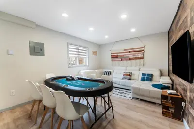 a living room with a poker table and a couch at Open Concept & Stylish-HotTub-Sauna-Billiard-Poker-BBQ in East Stroudsburg