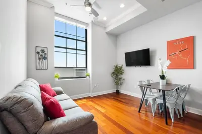 a living room with a couch and a table at Grand 1BR with Rooftop Pool & Gym in Philadelphia