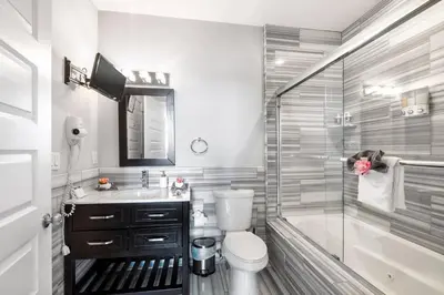 a bathroom with a shower and a toilet and a sink at Grand 1BR with Rooftop Pool & Gym in Philadelphia