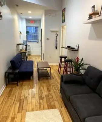 a living room with a couch and a table at Northern Liberties Fishtown Central Cozy Quaint in Philadelphia