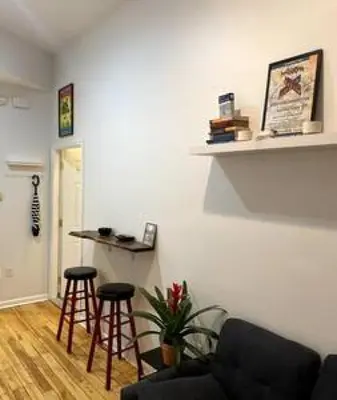 a living room with a couch and two bar stools at Northern Liberties Fishtown Central Cozy Quaint in Philadelphia