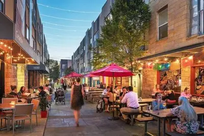 a group of people sitting at tables on a city street at Northern Liberties Fishtown Central Cozy Quaint in Philadelphia
