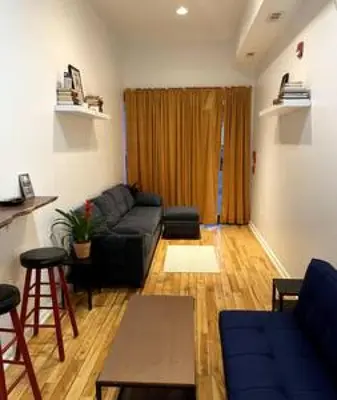 a living room with a couch and a table at Northern Liberties Fishtown Central Cozy Quaint in Philadelphia