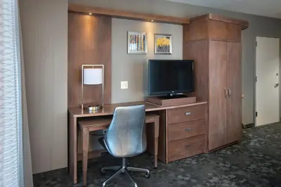 a room with a desk with a television and a chair at Courtyard by Marriott Philadelphia Lansdale in Lansdale