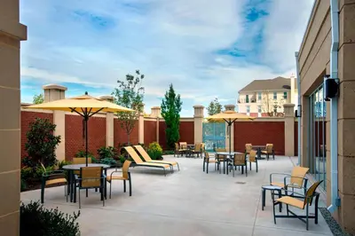 a patio with tables and chairs and umbrellas at Courtyard by Marriott Philadelphia Lansdale in Lansdale