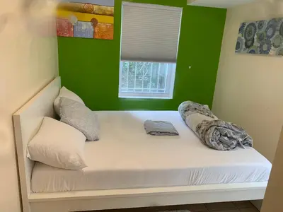 a bed in a room with a green wall at The Green Place of Newark in Newark
